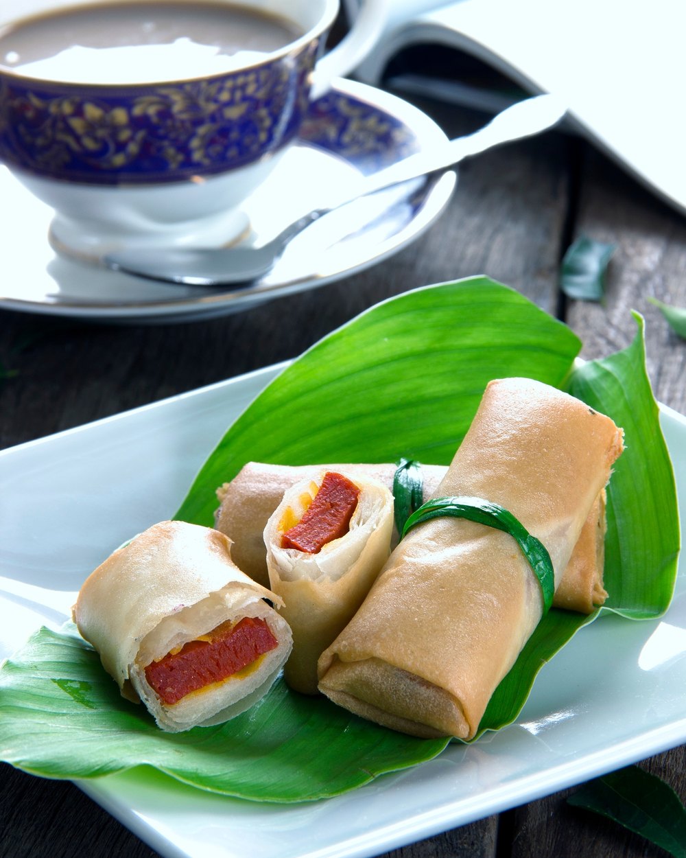 Popiah Otak-Otak rolls on a patterned plate